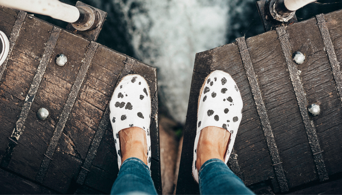 feet on bridge over water