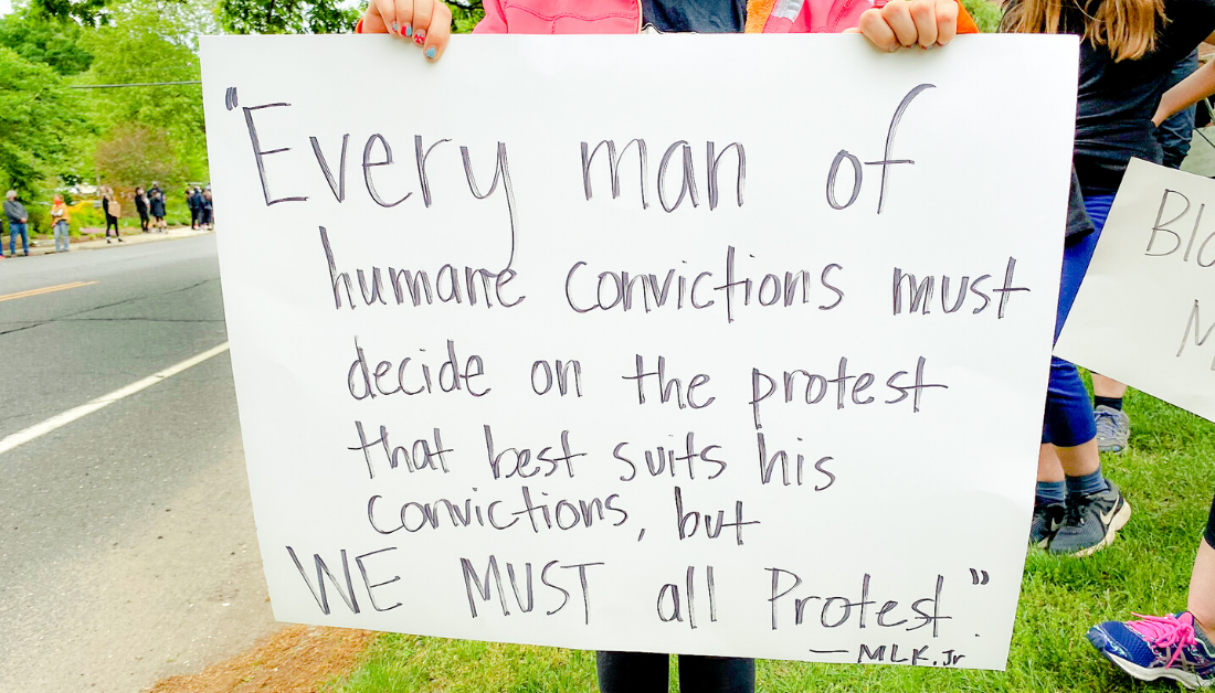 holding sign at protest