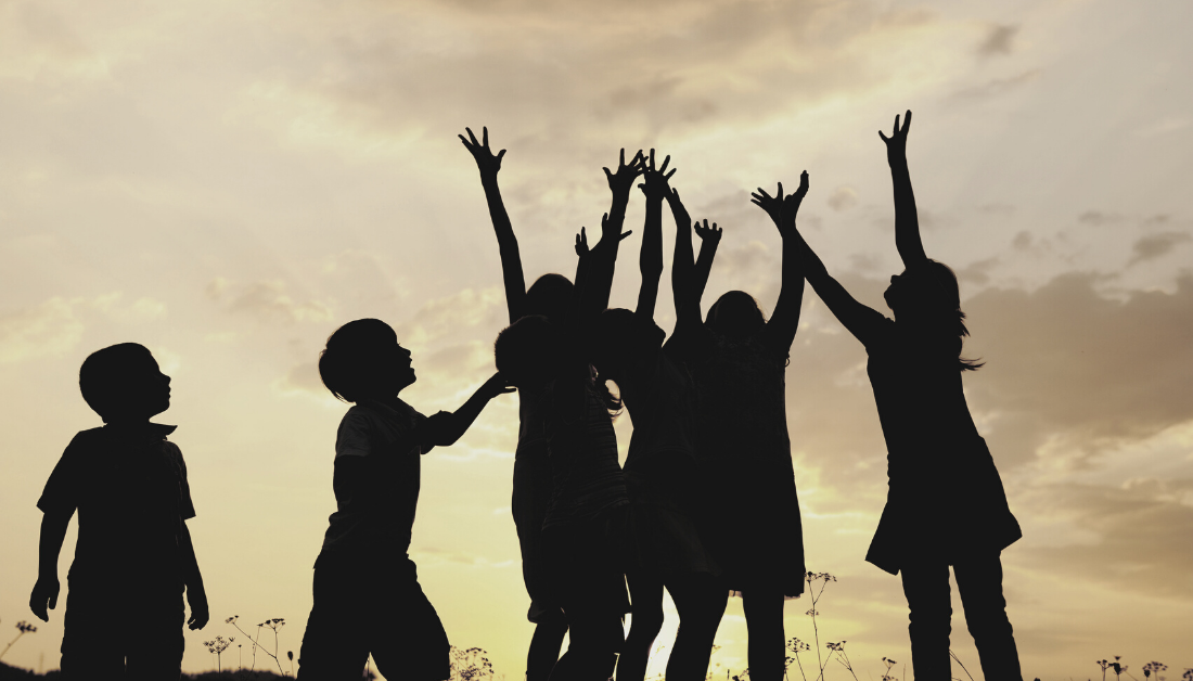 children silhouettes reaching for sky