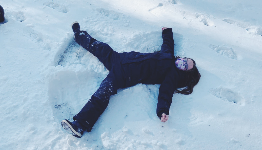 10-year-old girl making snow angel