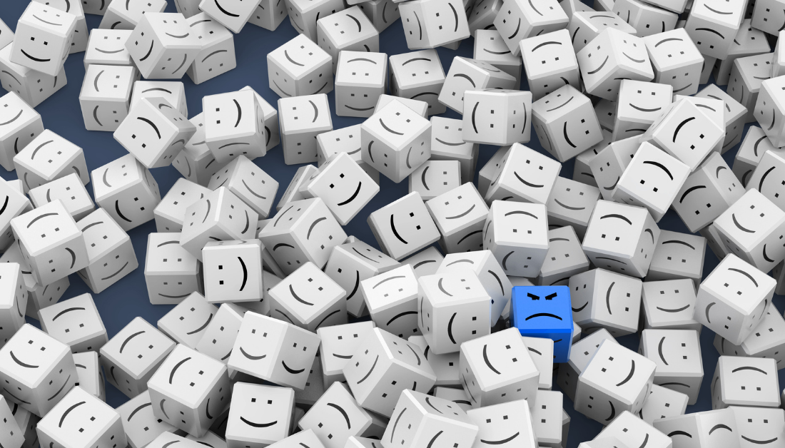 picture of white dice with happy faces and one blue dice with a grumpy face