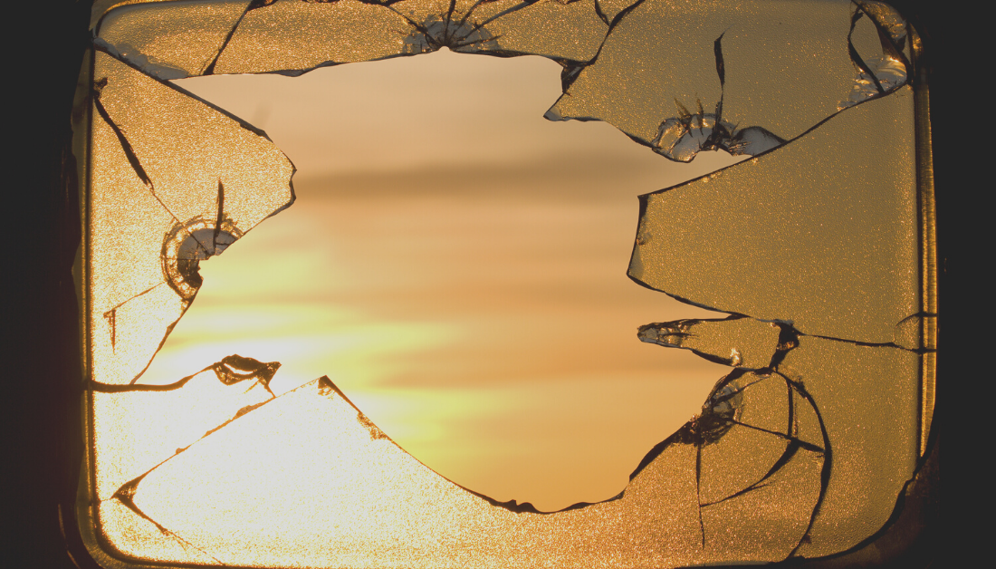 picture of a sunrise seen through broken glass