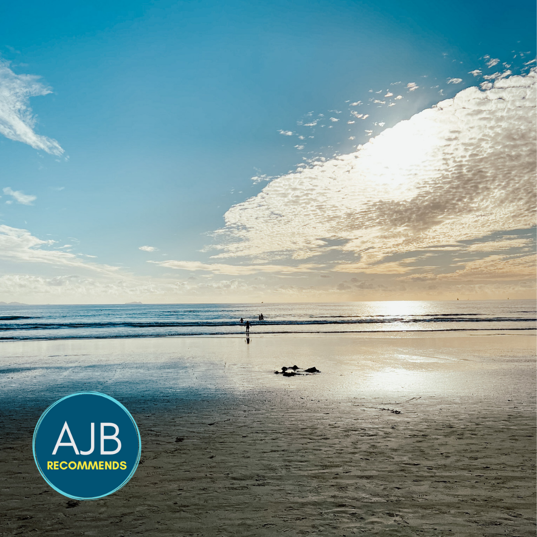 picture of sunset on a beach with clouds and blue sky