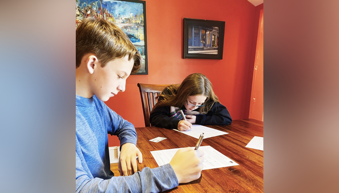 picture of William and Marilee sitting at the table filling out forms