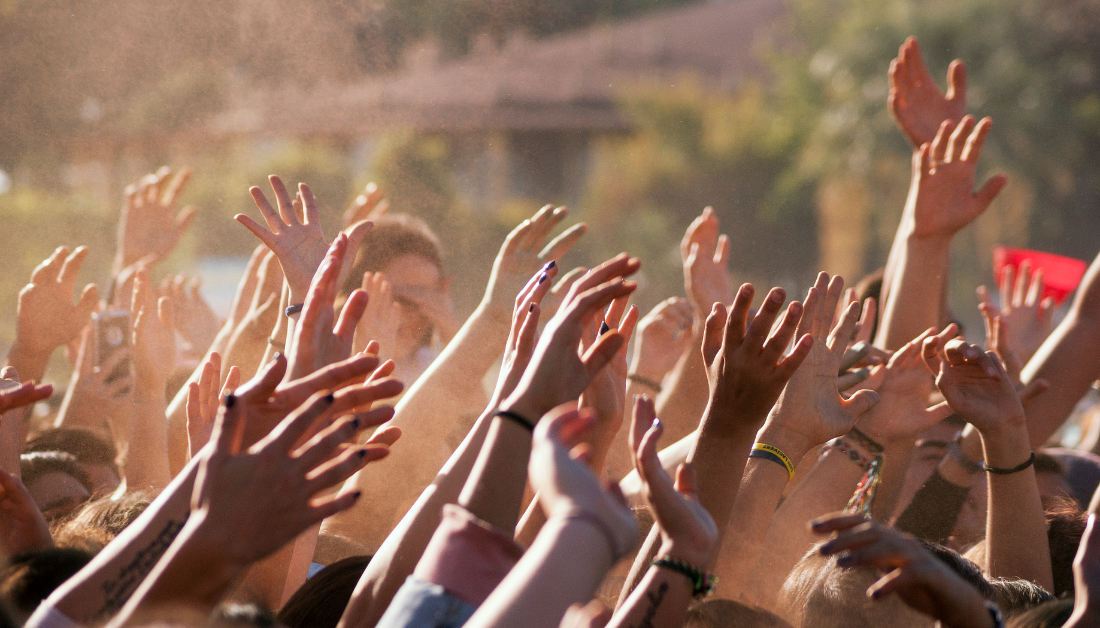 picture of white and black and brown hands raised up