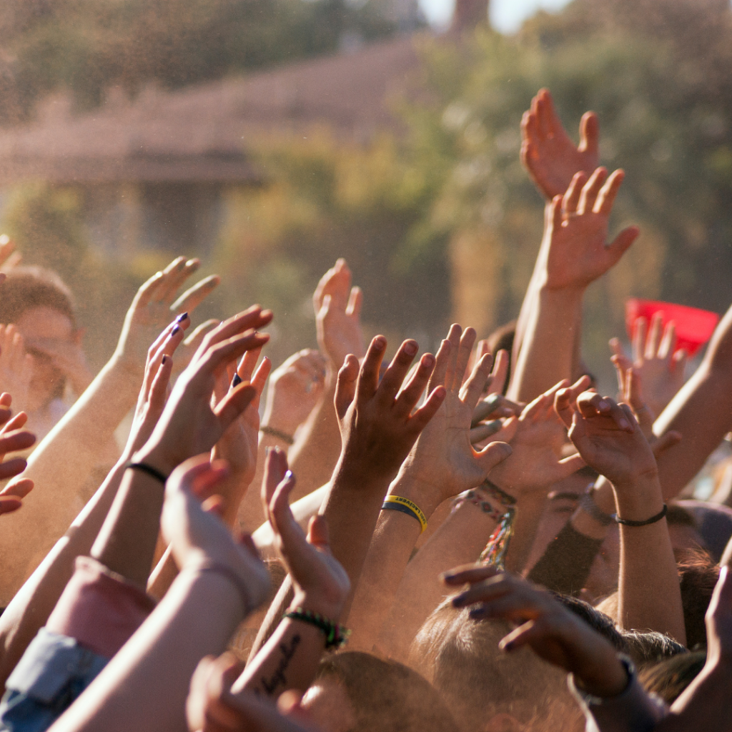 black, brown, and white hands raised in protest over George Floyd's death