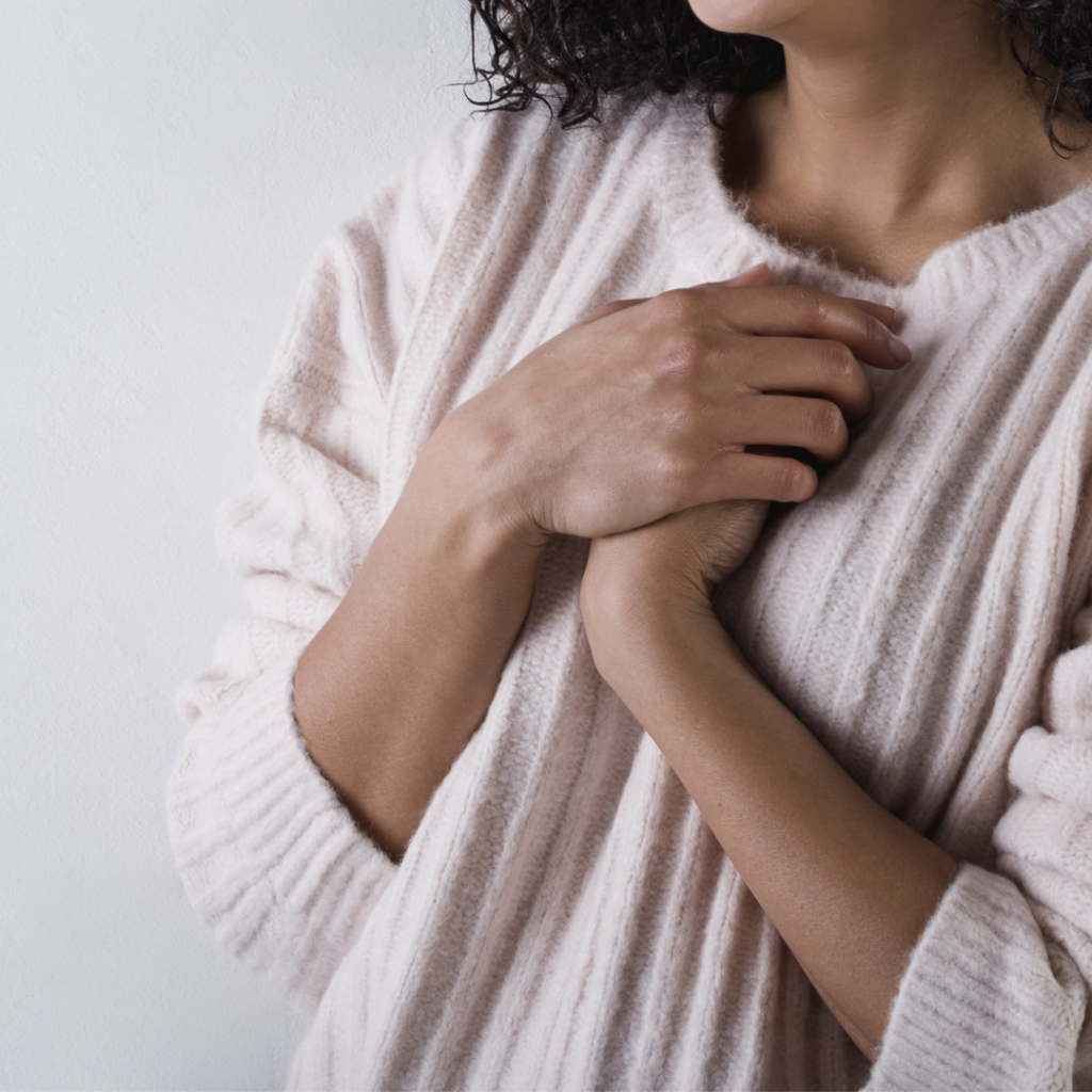 picture of hands clasped over heart in the language of the body