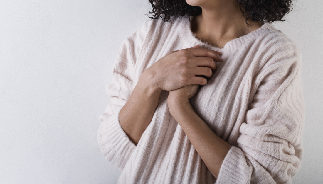 picture of hands clasped over heart