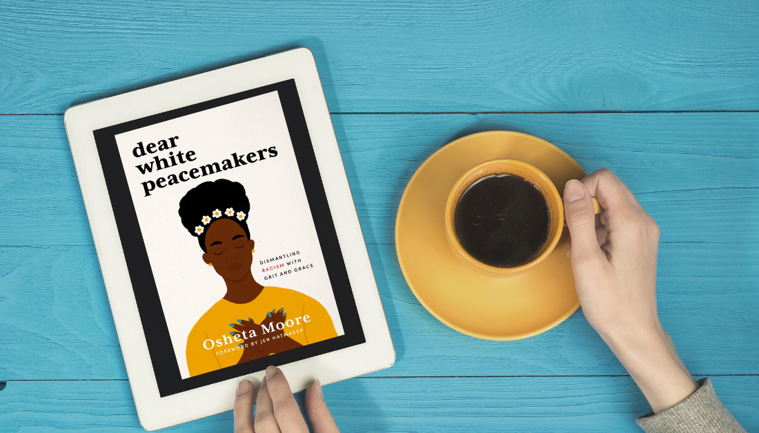 picture of a blue table and a pair of hands holding an ipad with a picture of Dear White Peacemakers and holding a cup of coffee