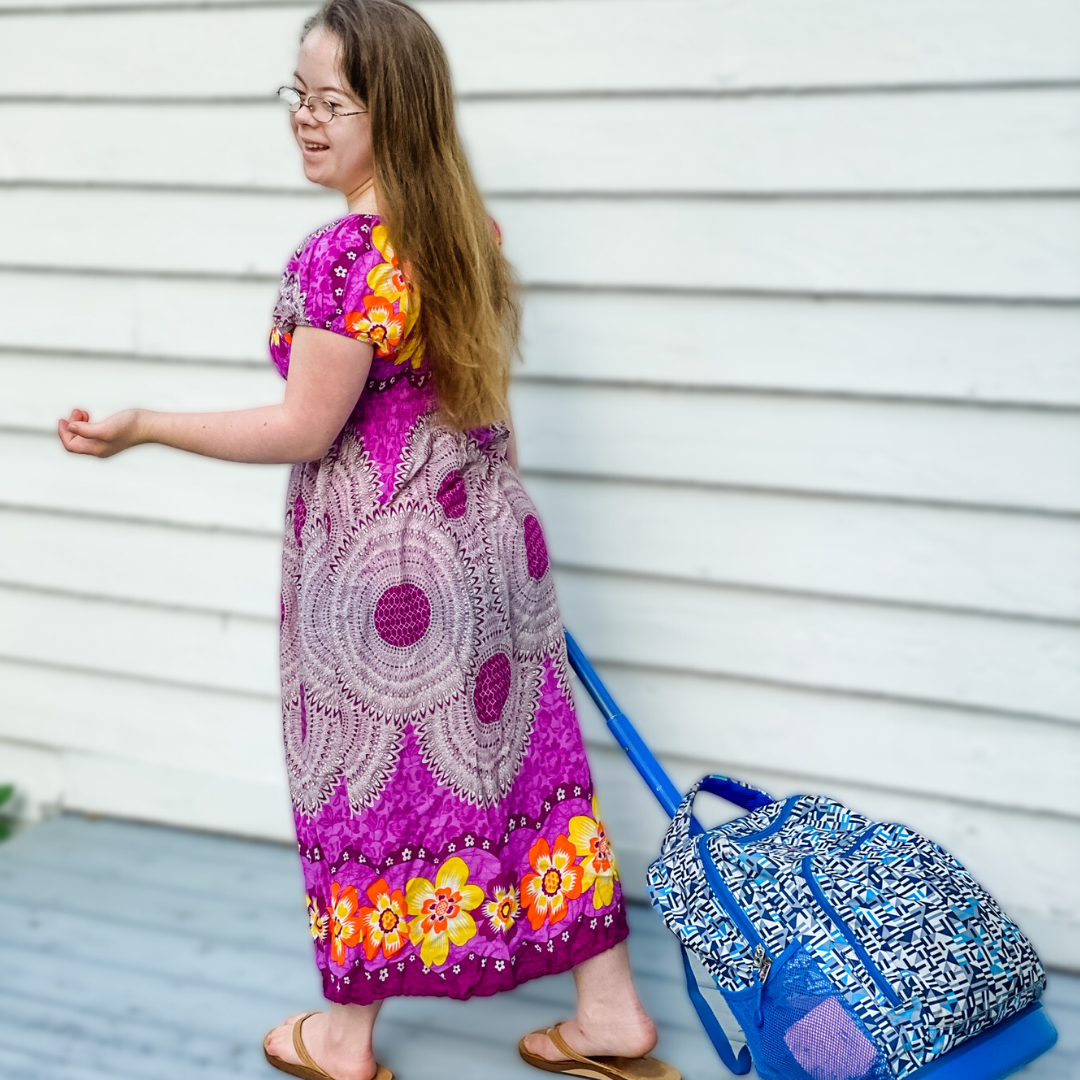 Penny, who has Down syndrome, walking away from the camera pulling her back pack on her way to high school