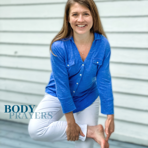 picture of Amy Julia smiling at the camera and holding up her foot with one hand and pointing to it with her other hand and text overlay that says Body Prayers