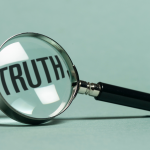 green image with magnifying glass magnifying the word Truth