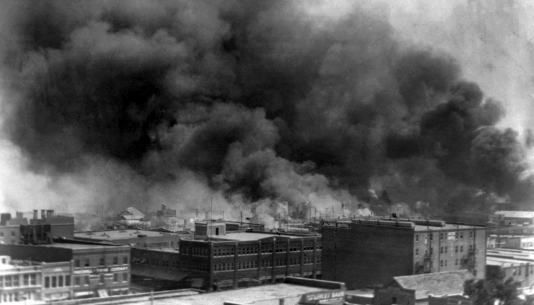 picture of building burning during the Tulsa Massacre in 1921