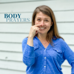 picture of Amy Julia pointing to her nose and text overlay that says Body Prayers