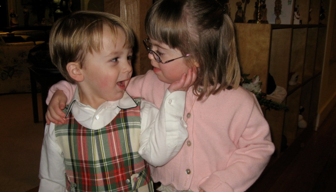William and Penny, as preschoolers, looking at each other with their arms around each other