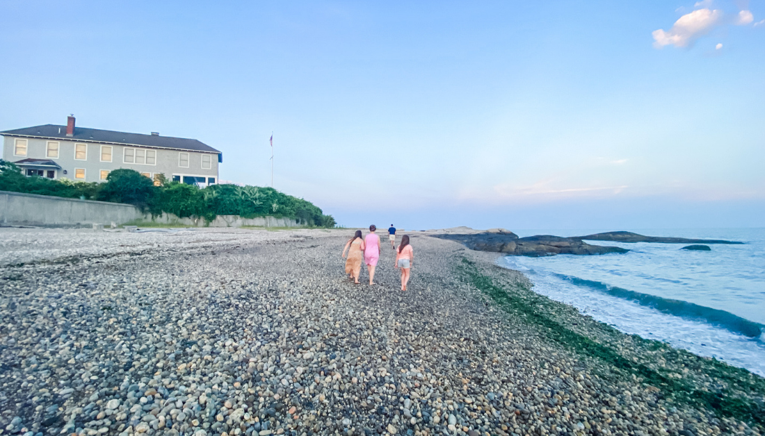 Marilee, Amy Julia, Peter, and Penny walking on the beach facing away from the camera