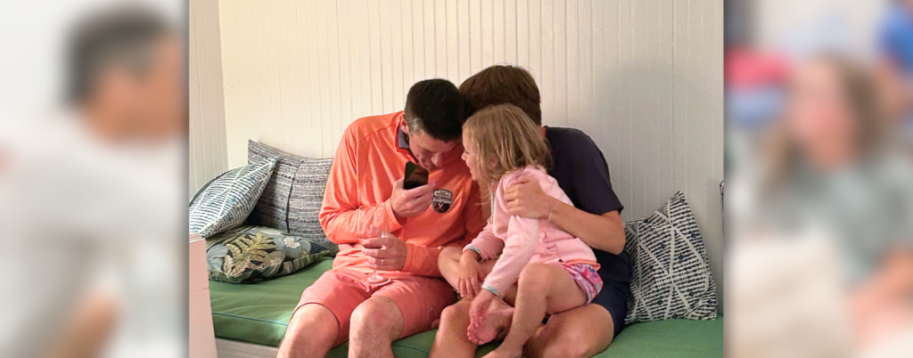 Peter, William, and a young cousin huddle together playing the name game