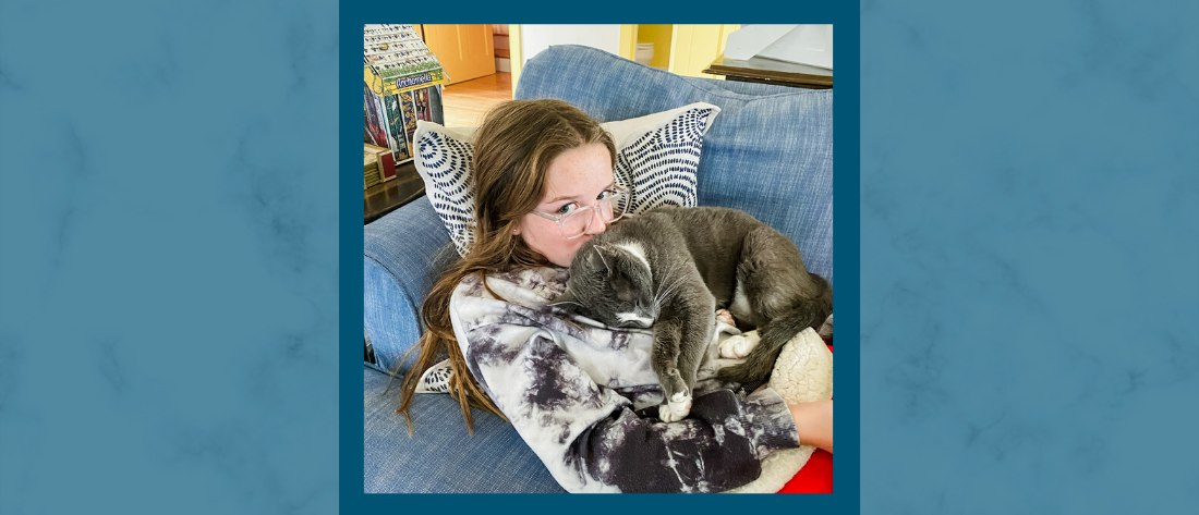 gradient blue graphic with a blue-framed picture of Marilee resting on the couch with her gray kitty