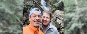 blurred picture of winter trees with picture overlay of Peter and Amy Julia in front of a water fall