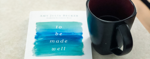 To Be Made Well book sits on a counter next to a mug of coffee