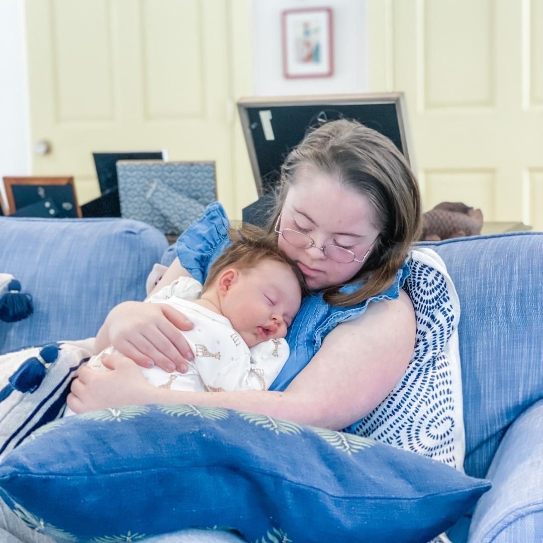 Penny snuggles with her baby cousin