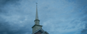 A weathered church steeple in a small American town.
