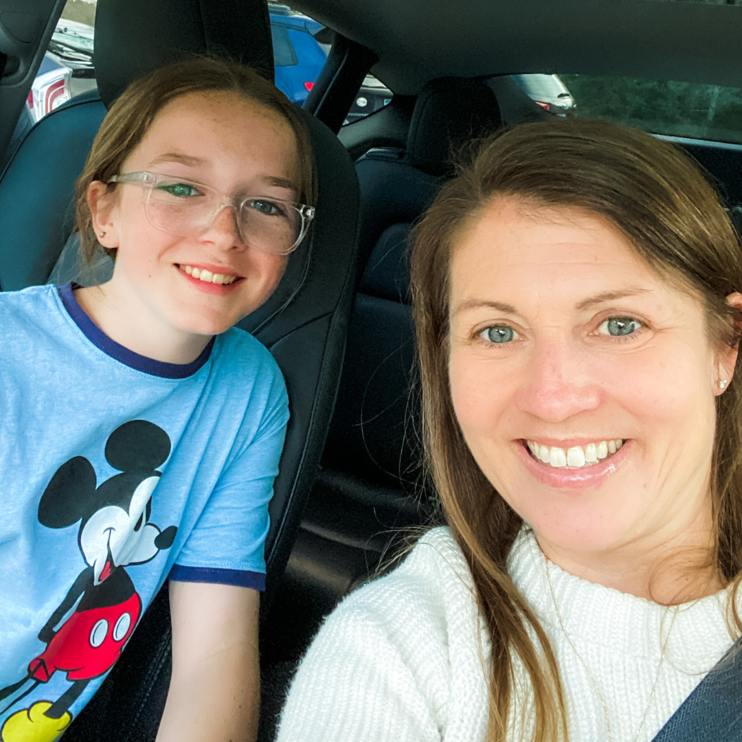 Marilee and Amy Julia sit in a vehicle and pose for a selfie