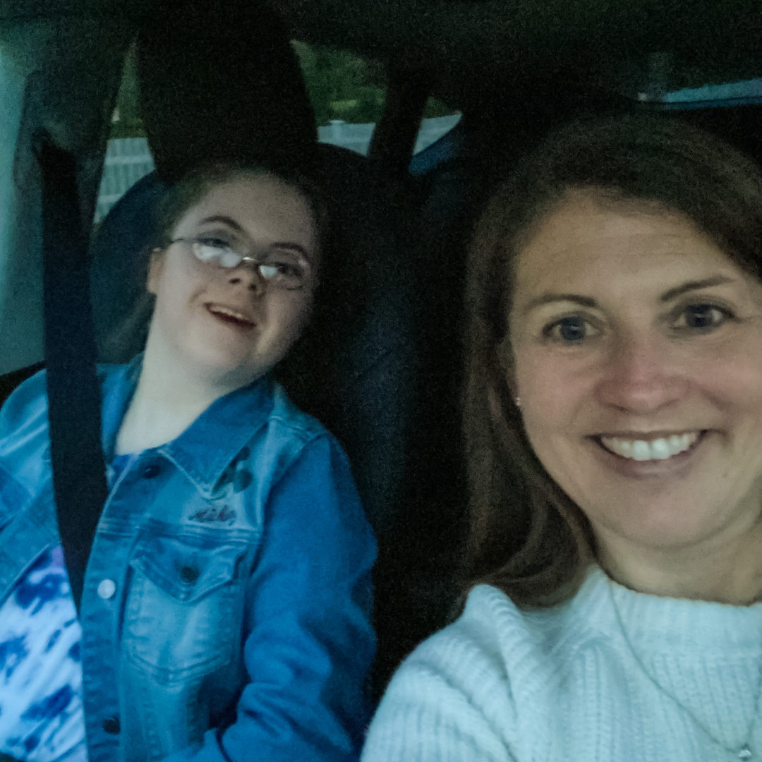 Penny and Amy Julia sit in a vehicle and pose for a selfie