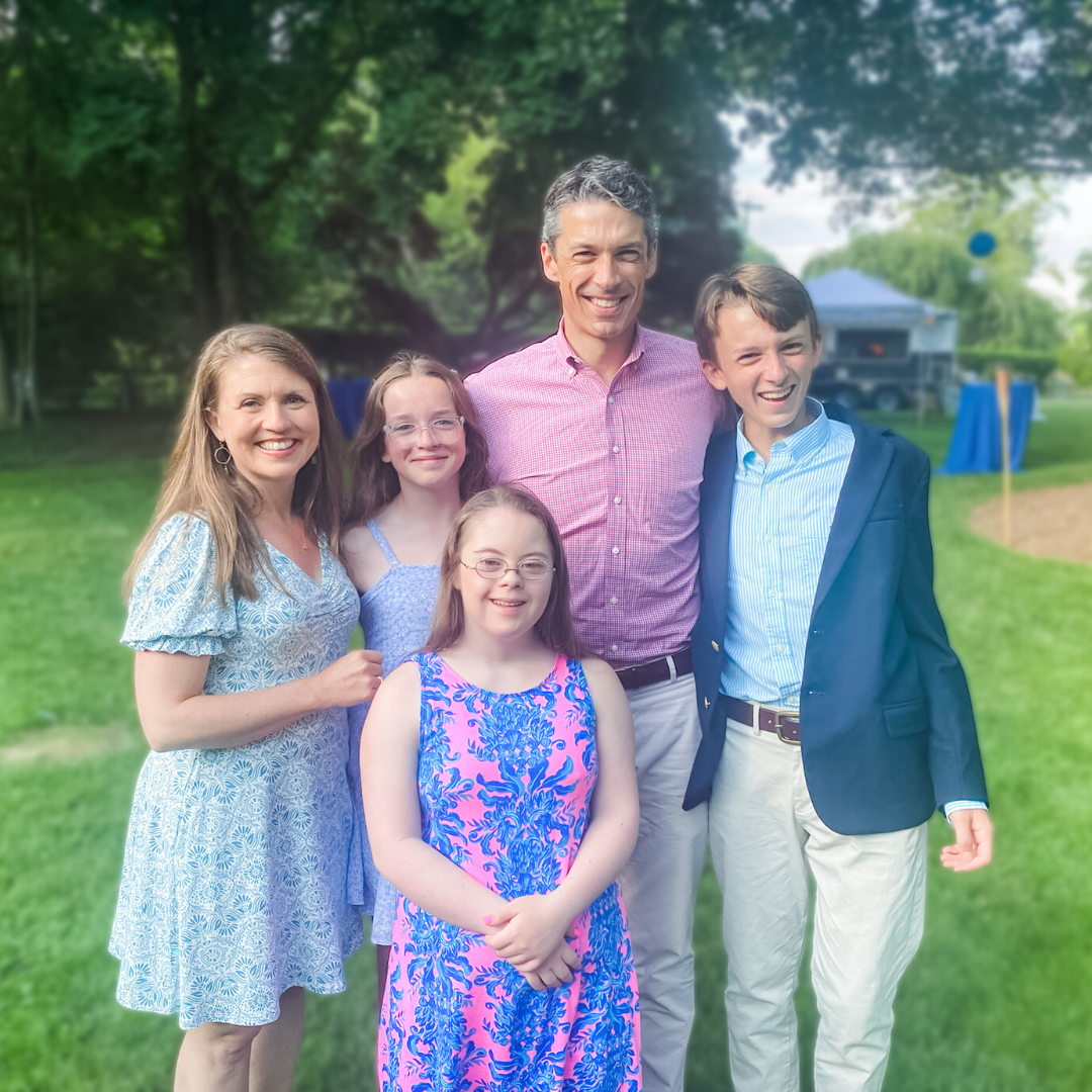 Amy Julia's family stands together and smiles at the camera at William's 8th grade grad party