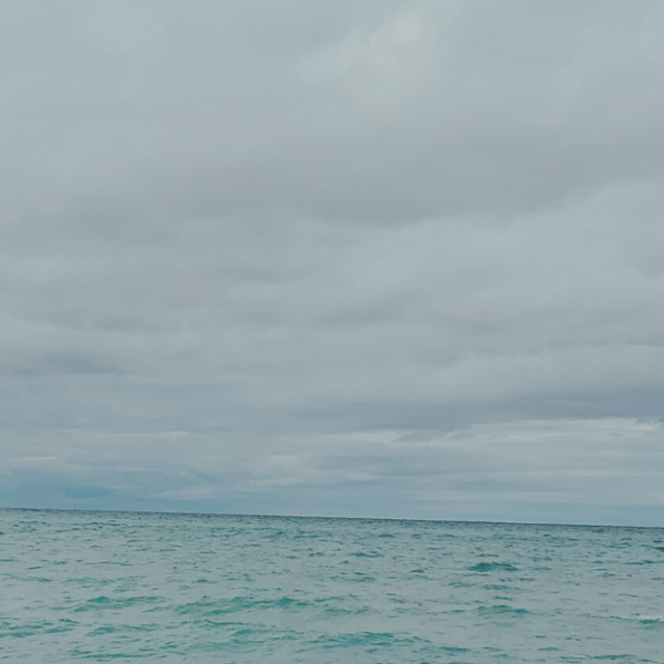 a blue lake meets a stormy horizon