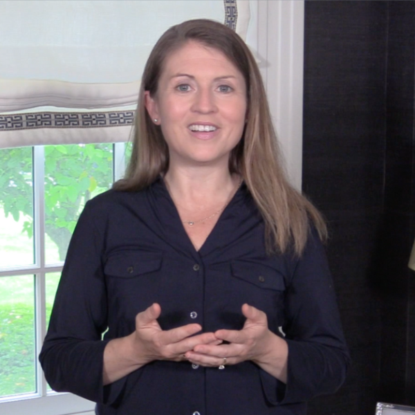 Amy Julia stands in front of a window and teaches