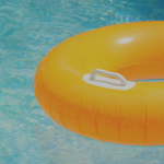 a yellow tube floating on water in a swimming pool