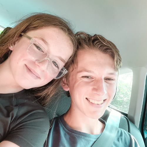 Marilee and William smile for a selfie in a vehicle