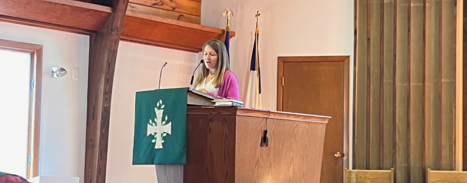 Amy Julia stands in the pulpit and preaches
