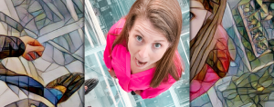 Amy Julia stands on the glass-encased floor of One Vanderbilt. Her mouth and eyes are wide open and she looks up at a camera high above her.
