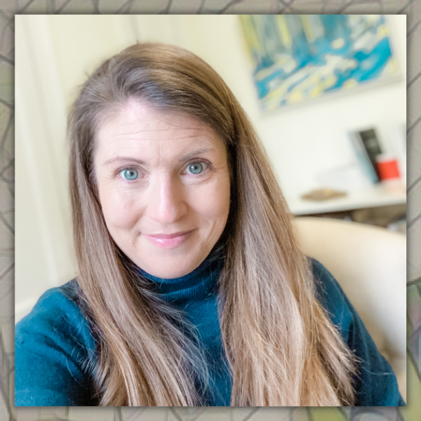 mosaic background behind a photo of Amy Julia sitting in her office and smiling for a selfie