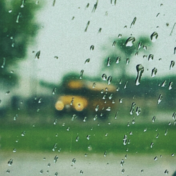 photo of a school bus seen through a rain-covered window