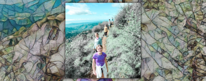 mosaic background behind a photo of Amy Julia's family stands in a single file line on a path high above a valley