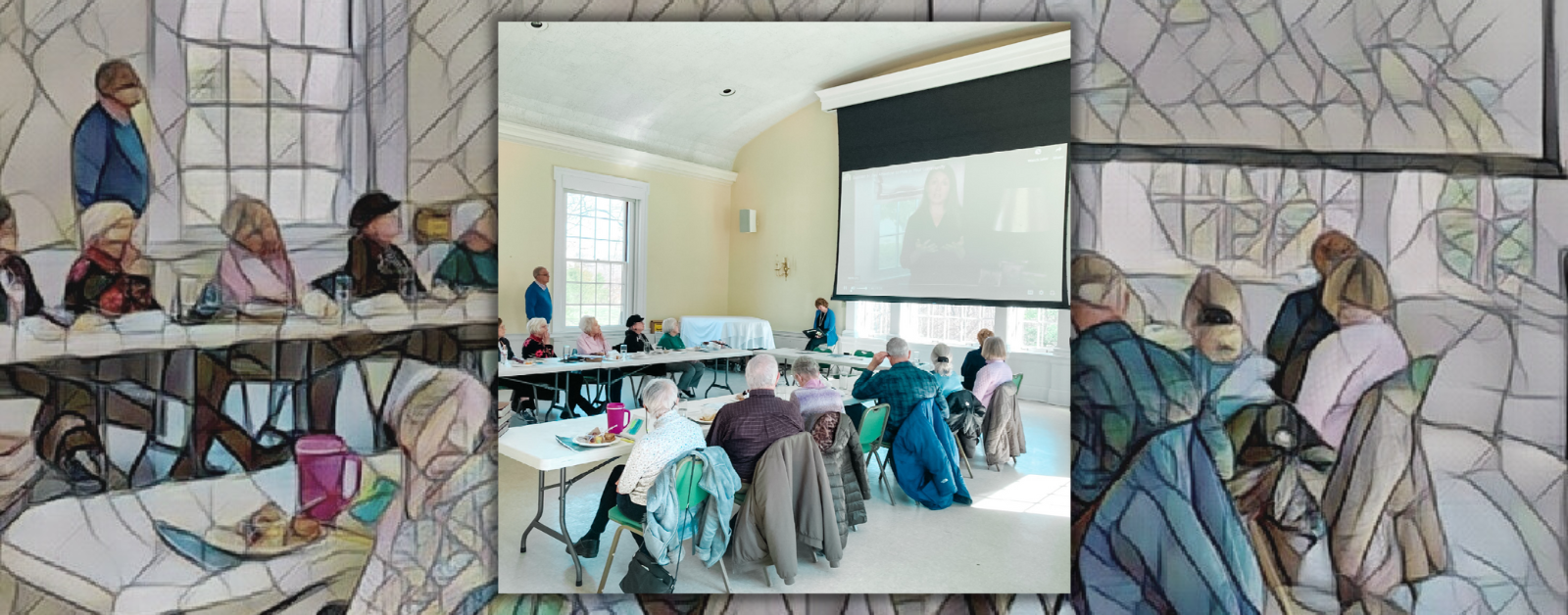 photo of a group of people sitting in a classroom with high ceilings and windows in a church and looking at a large screen with a video of Amy Julia