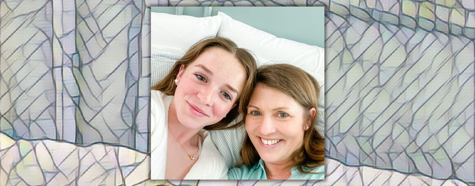 Marilee and Amy Julia smile at the camera for a selfie as they rest in bed