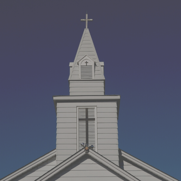 photo of a church steeple against a blue sky