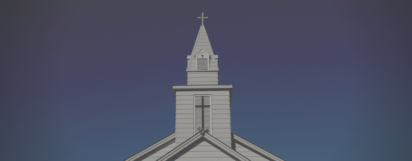 photo of a church steeple against a blue sky