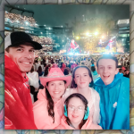 photo of the family smiling and drenched from rain at a Taylor Swift concert