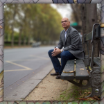 photo of Tim Keller sitting on a bench in a city