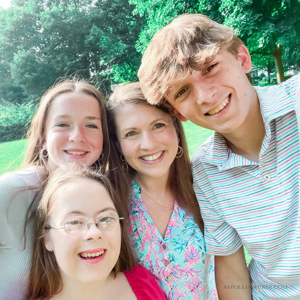 photo of Penny, Marilee, Amy Julia, and William crowding together for a selfie outside