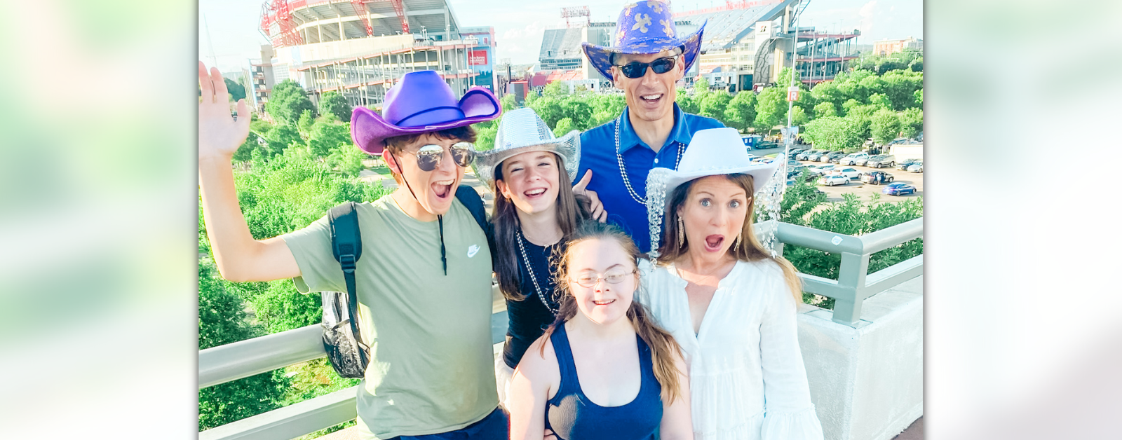 Amy Julia and family make silly faces on a bridge in Nashville before the Beyonce concert