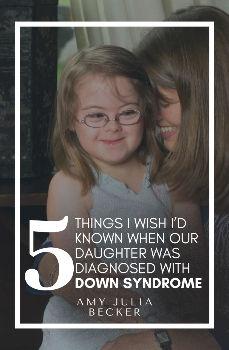 photo of Amy Julia smiling and leaning her head against Penny's head, who is a young girl with Down syndrome. She sits on Amy Julia's lap.