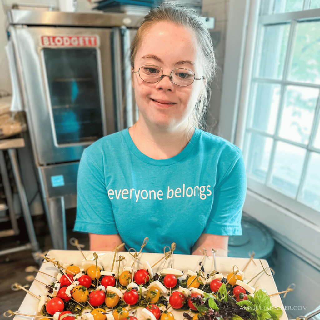 photo of Penny holding a tray of veggie skewers at the Po Cafe 