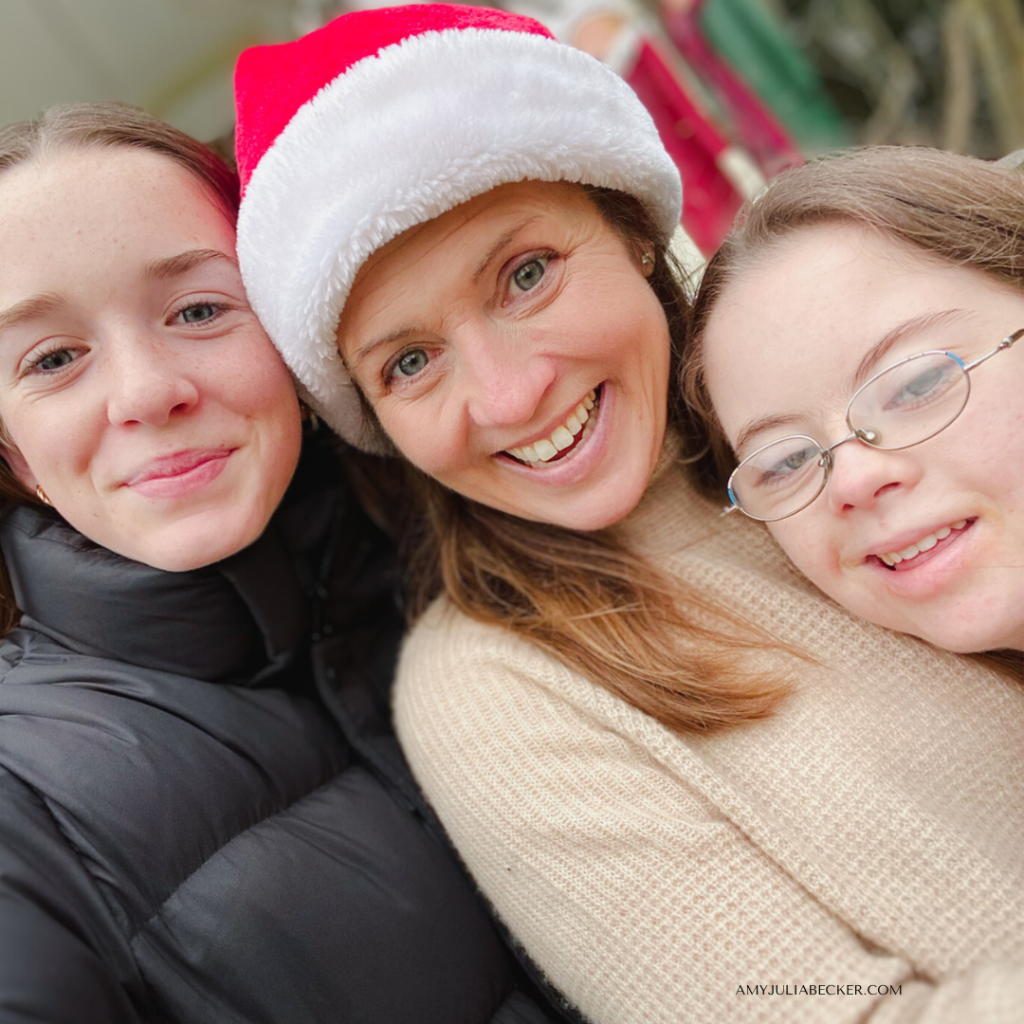 selfie of Marilee, Amy Julia, who is wearing a Santa hat, and Penny