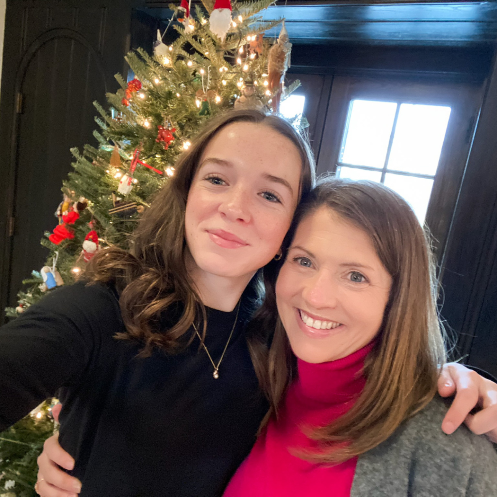 Marilee and Amy Julia taking a selfie in front of a christmas tree